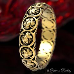 a gold ring with flowers on it