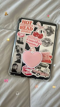 a book with stickers on it laying on a bed