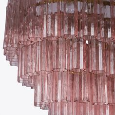 Four tiers of fluted glass tubes create this beautiful mid-century inspired dining chandelier. The textured glass tubes are individually hung from an oval shaped Satin Brass frame. This style is available in three colours; a rich, sophisticated Smoked Quartz, a fresh blush Pink or clear glass. Ideal for hanging over our Saint Laurent dining table. UK Plug (up to 250V). Luxury Pink Statement Chandelier Earrings, Pink Chandelier Aesthetic, Gold Pendant Lamp, Pink Glass Chandelier, Chandelier Pink, Chandelier Pink Crystal Chandeliers, Dining Chandelier, Rose Crystal, Fluted Glass