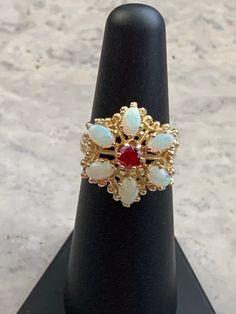 Vintage Genuine Opals and Ruby Ring  Gold plated pure silver ring and setting  Size 5 3/4 Colorful opals Oval Opals each measure 5 x 3 mm with a 2 mm depth  Round cut simulated ruby measures 4 mm with a 2 mm depth  Beautiful Victorian Style Cocktail Ring! October and July Birthstones 1970-1980's ring Star seller shop Over 600 pieces sold on Etsy Hand set by experienced jeweler  Free Shipping! Antique Opal Ring, Victorian Style Rings, Ruby Ring Gold, Opal Band, And July, Opal Ring, Multi Stone Ring, Ruby Ring, Ring Gold