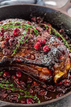 meat with cranberry sauce in a cast iron skillet