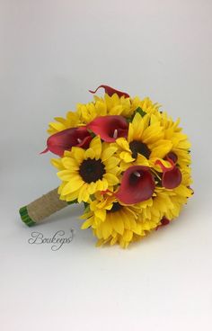 a bouquet of sunflowers and red calla lilies on a white background