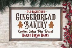 an old fashioned gingerbread bakery sign hanging on a wall next to some red berries