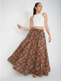 Our Venessa printed skirt, made from soft cotton fabric, features an A-line silhouette perfect for most body types. This regular-fit Kalamkari skirt with an elasticated waistband is a great option for all-day wear, especially during the summer months. Kalamkari is a highly popular form of block-printed cotton textile produced with the help of kalam, meaning pen. During the process, a sharp-pointed pierced bamboo regulates the flow of color/organic dye on the fabric. This maroon-colored skirt comes with one pocket, making it an ideal casual-wear wardrobe staple. To add some extra fun, you can pair it with a monotone shirt or top and elevate your style effortlessly. Material: Cotton Style/Print: Kalamkari Waist: 30” Length: 39” Fit: A-line Occasion: Casual Color: Maroon Lining: No Long Cotton Skirt With Elastic Waistband, Cotton Long Skirt With Elastic Waistband, Floral Print Cotton Midi Skirt, Cotton Midi Skirt With Floral Print, Cotton Maxi Skirt With Elastic Waistband And Flared Shape, Cotton Flared Maxi Skirt With Elastic Waistband, Casual Printed Cotton Skirt, Flowy Flared Cotton Maxi Skirt, Cotton Flared Maxi Skirt