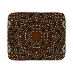 a brown and black abstract pattern on a white background bath mat with an intricate design in the center