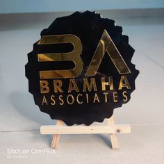 a black and gold plaque with the name braamha associates on it's side