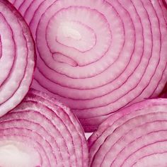 red onions are piled up in a pile