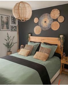 a bed room with a neatly made bed and some pictures on the wall above it