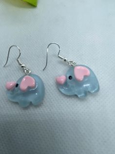 SHIP WITHIN US ONLY THXSuper cute pale blue elephants, clear coated. Have pink heart shaped ears and cute pink heart on end of their trunk. Adorable baby elephant charms. I added surgical steel ear wires to make these cute lightweight earrings. All materials used are marked nickel free. Theses resin charms are lightweight.  These are new hand crafted  Local regulations do not allow returns on pierced jewelry  I ship daily via first class mail with tracking. I do combine orders to cut your postal cost Please reach out to me with any questions and thank you for looking. Check out my other listings for fun , unique earrings. And there are more elephant's.PLEASE NOTE:  I only ship within the USA   Current postal rates  and lack of reliable tracking on international orders makes it impossible Cute Pink Heart, Earrings Hearts, Elephant Earrings, Blue Elephant, Elephant Charm, Blue Elephants, Pierced Jewelry, Resin Charms, Lightweight Earrings