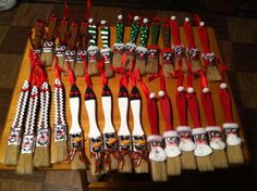 the brooms are lined up on the table to be used as christmas stockings and other decorations