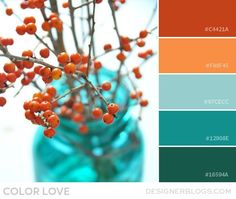 a blue vase filled with red berries on top of a white tablecloth and color swatches