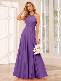 a woman in a long purple dress posing for the camera