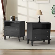 two black nightstands sitting next to each other on top of a rug