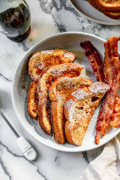 french toast and bacon in a bowl on a marble table