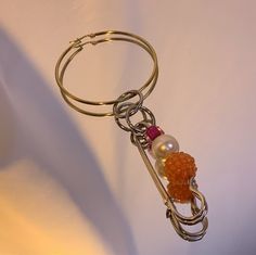 a keychain that has some kind of thing on it with beads attached to it