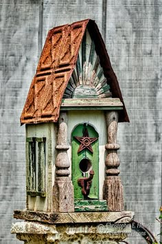 the bird house is painted green and brown