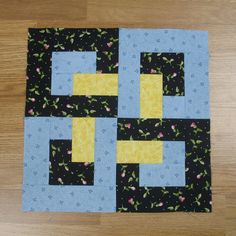 the block is made up of black and yellow squares with blue trims on them