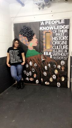 a woman standing in front of a black and white door