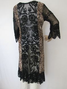 This  one of a kind, bohemian style coat-dress is wearable art.  The coat dress is handmade combining elegant lace with some beading, soft pleated animal print, crochet sleeves and hem border with a front gold lame tie belt.  The coat dress is an original design that provides comfort in a sophisticated retro style.  Flaunt your good taste when you wear this classy couture piece. Long Lace Fall Dress, Long Lace Dress For Fall, Bohemian Fitted Dress With Open Front, Fitted Open Front Bohemian Dress, Bohemian Evening Dresses For Fall, Bohemian Dress With Lace Sleeves, Bohemian Party Dress With Crochet Trim, Bohemian Fitted Dress With Lace Sleeves, Fitted Bohemian Dress With Lace Sleeves