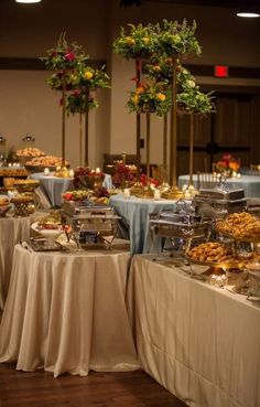 a banquet table is set up with many different foods and desserts on the tables