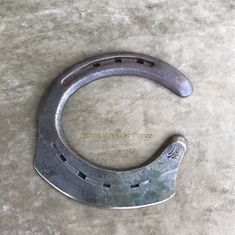 a metal clamp sitting on top of a cement floor