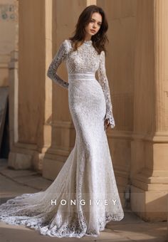 a woman in a white wedding dress posing for the camera with her hands on her hips