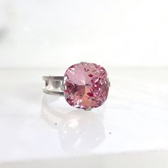 This shimmering crystal cocktail ring resembles a precious gem. I've securely set a sizable 12mm, light pink Swarovski square cushion-cut crystal onto a Nickel Free, silver-plated adjustable ring (smallest size approx. 5). Boasting a near-7-carat crystal, it's ideal for any momentous event or everyday flair. Ships Free • Handmade in the USA Pink Crystal Open Ring For Formal Occasions, Pink Adjustable Ring For Formal Occasions, Pink Adjustable Formal Rings, Formal Adjustable Pink Rings, Pink Swarovski, Precious Gems, Sparkling Crystal, Crystal Rings, Color Rosa