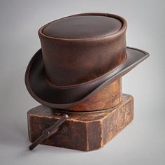 If you want to make the ultimate impression that causes an uproar of attention, then a top hat is the way to go. And our Marlow Unbanded design is a classic. Featuring all-leather construction with a shapeable brim, the Marlow says what you want it to say in your choice of three gorgeous colors; Black, Brown, or Burnt Honey. #hats #leatherhats #tophats Burnt Honey, Leather Top Hat, American Hat Makers, Steampunk Top Hat, Top Hats, Quality Hats, Leather Hats, Leather Work, Mens Leather