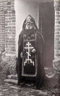 an old black and white photo of a priest