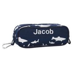 a blue and white pencil case with sharks on the front, name jacob