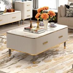 a living room filled with furniture and flowers on top of a coffee table in front of a window