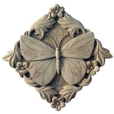 an intricately carved butterfly with leaves and flowers