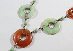 -Antique Chinese Sterling Silver Disk Natural Carnelian with Jadeite Necklace -Total length: 15.5 in -Small disk carnelian size:about 17.75 mm -Jadeite disk & big carnelian disk size: 25 mm -Jadeite pendant size: 21 mm x 13 mm x 3.4 mm (thickness) -Small jadeite bead size:about 5 mm -Total weight: 18.5 g -Marked sterling Vintage Natural Stones Gemstones, Vintage Round Natural Gemstones, Vintage Jade Necklace With Natural Stones, Vintage Oval Jade Necklace, Green Multi-stone Round Necklace, Green Multi-stone Round Necklaces, Coral Earrings, New City, Earrings Photo