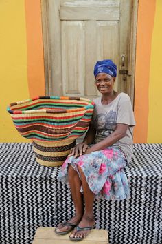 a woman sitting on top of a table next to a basket