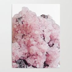 a close up of pink crystals on a white background