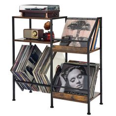 a book shelf filled with vinyl records and cd's on top of each other