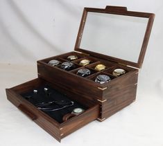 Ready to ship: Watch box : Lets you display your prized watches. Holds 8 watches and has a accessory/cufflink drawer; 8 black pillows included. The box is constructed of walnut. The box bottom is lined with black suede cloth. The sides are from the same board with a continuous grain pattern. The corners are mitered and glued together with maple splines for strength and extra beauty. The box is finished with three coats of danish oil with a top coat of wax. Custom engraving available: Click on this link for details https://www.etsy.com/listing/291878067/custom-laser-engraving?ref=shop_home_active_52 Click here to view my watch box section: https://www.etsy.com/shop/CarolinaWoodshop/edit?ref=seller-platform-mcnav&section_id=15328860 Note: All of my boxes with a glass top are made so the glas Wood Watch Box, Black Pillows, Danish Oil, Organization Boxes, Watch Box, Luxury Watches For Men, Wood Watch, Top Coat, Storage And Organization