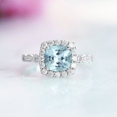 Beautiful Cushion Aquamarine Ring ►Made of solid sterling silver with rhodium finish (925) ►Accented with simulated diamonds (CZ) ►Average band width: 2.3 mm Center Stone: Aquamarine Shape: Cushion Measurements: 7.0 x 7.0 mm Carat Weight: 2 ct. (approx.) Gemstone creation: Lab-Created ✓ 100% Nickel-Free ✓ Hypoallergenic ✓ Comfort Fit ✓ Free Ring Box ✓ Free USA Shipping ✓ Ready to ship next business day Popular Engagement Rings, Aquamarine Engagement Ring, Aquamarine Ring, Ring Art Deco, Creating Jewelry, Wedding Ring Designs, Aquamarine Rings, Solid Gold Jewelry, Anniversary Gift For Her