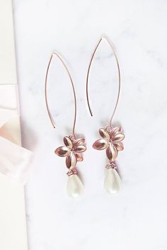 Rose gold pearl earrings long. These  rose gold dangle earrings are the perfect finish to your wedding look. #rosegoldpearlearrings Elegant Rose Gold Teardrop Bridal Earrings, Delicate Rose Gold Pearl Earrings For Formal Events, Delicate Rose Gold Pearl Earrings For Formal Occasions, Rose Gold Delicate Pearl Earrings For Formal Occasions, Elegant Rose Gold Teardrop Pearl Earrings, Elegant Rose Gold Teardrop Earrings, Rose Gold Pearl Drop Flower Earrings, Rose Gold Dangle Pearl Earrings For Formal Occasions, Rose Gold Flower Drop Earrings With Pearl