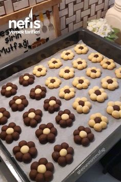 chocolate and white cookies are arranged on a cookie sheet in the shape of flower petals