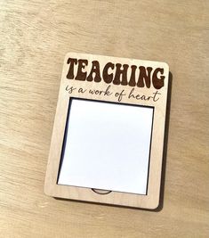 a wooden frame with the words teaching is a work of heart