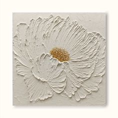 a white and gold flower painted on the wall in an art gallery with textured paint