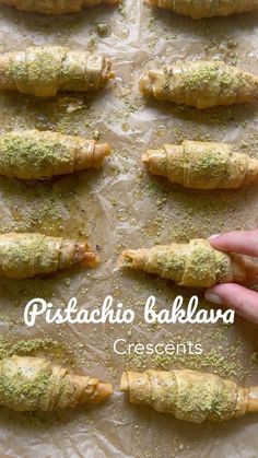 there is a hand that is holding some food on a sheet of wax paper with the words pistachio bakkara