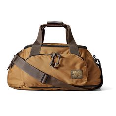 a brown duffel bag sitting on top of a white floor