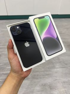 someone holding an iphone in their hand with the box open to show it's new design