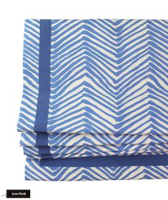 the blue and white chevroned fabric is folded on top of each other