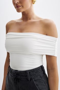 Your everyday staple. The MEENA Recycled Nylon Off-Shoulder Top seamlessly blends sustainability with style. Boasting an off-shoulder design and a ruched, foldover neckline, it adds texture and dimension to the look. With a slight bodycon fit, it flatters the silhouette while ensuring comfort. The cropped torso design introduces a playful element, making it a versatile piece suitable for various occasions. Crafted from recycled nylon, this top not only reflects a fashion-forward taste but also p Spring One Shoulder Stretch Tube Top, Ruched Nylon Tops For Summer, Spring One-shoulder Stretch Tube Top, Chic Nylon Tube Top For Summer, Stretch Nylon Tube Top For Summer, Strapless Nylon Tops For Summer, Casual Strapless Off-shoulder Top, Stretch Off-shoulder Tube Top For Summer, Strapless Nylon Tops For Spring