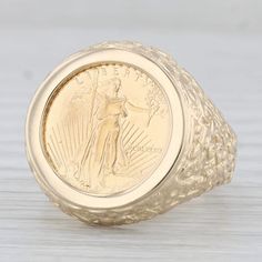 Metal: 14k Yellow Gold Ring, 22k Yellow Gold Coin Weight: 12.2 Grams  Stamps: 14k Face Height: 21.2 mm  Rise Above Finger: 5.2 mm Band / Shank Width: 2.9 mm This ring is a size 10, but it can be resized down 3 sizes for a $20 fee or up 2 sizes for a $40 fee. If you would like your ring resized, please select the appropriate fee from the listing below in order to pay the sizing fee: https://www.etsy.com/listing/781388346/ring-sizing-service-fee Each piece is thoroughly examined and refinished as needed by our professional jewelers, graded by our in-house GIA (Gemological Institute of America) Graduate Gemologist, and inspected for quality before being carefully packaged and promptly shipped. [SKU: B30587] phd 5 Dollar Gold Coin Ring, Commemorative Yellow Gold Rings Stamped 14k, Commemorative Stamped 14k Yellow Gold Ring, 14k Yellow Gold Engraved Ring For Commemoration, 14k Gold Engraved Commemorative Ring, 14k Gold Engraved Commemoration Ring, Yellow Gold Signet Ring For Commemoration, Collectible Yellow Gold Engraved Ring, Classic Yellow Gold Jewelry For Commemoration