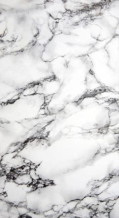 a white marble counter top with black and grey veining on it's edges