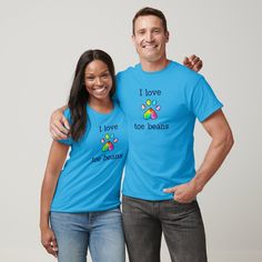 a man and woman wearing matching t - shirts that say i love toe beans with paw prints